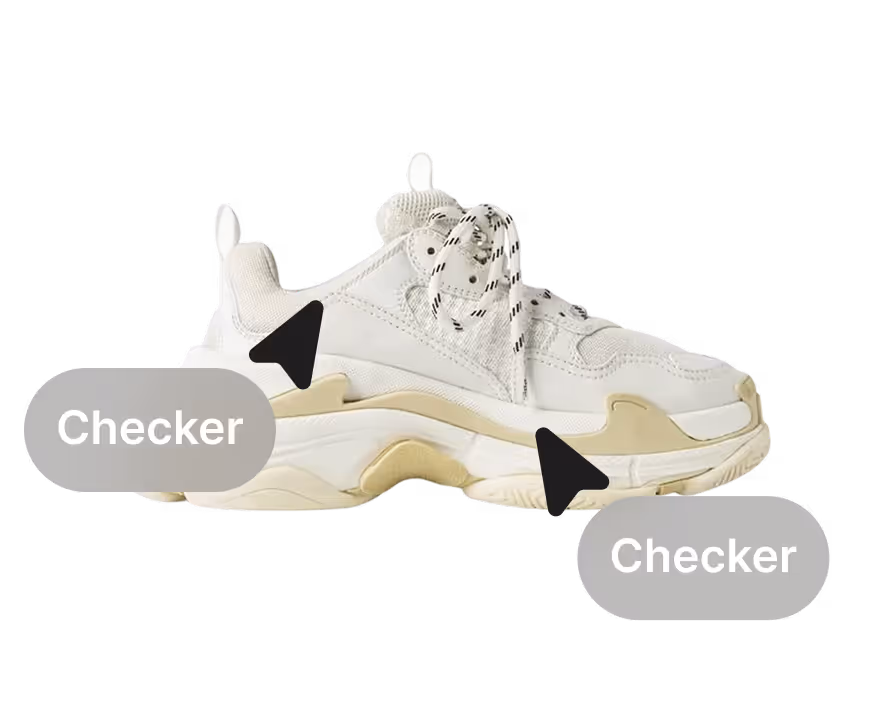A sneaker being checked by two professionals.